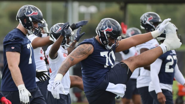 Texans outside linebacker Juice Scruggs (70) stretches during rookie camp at the Methodist practice facility.